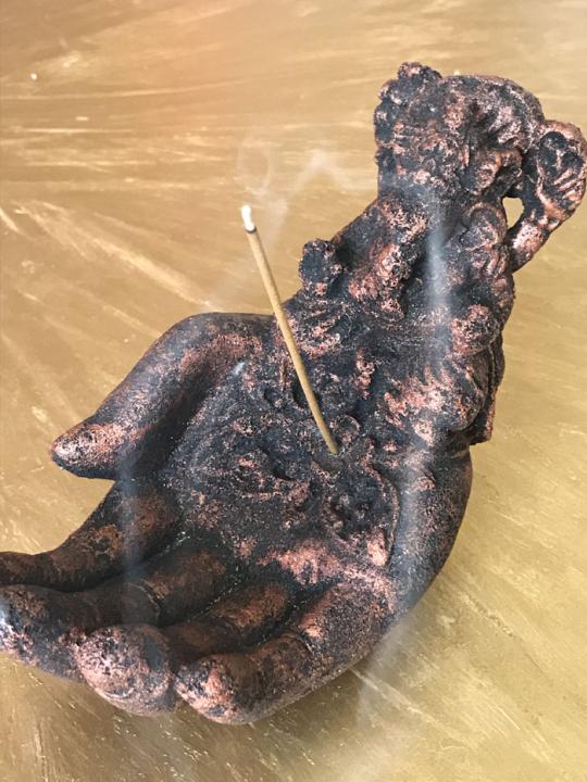 Hand with Ganesha incense holder